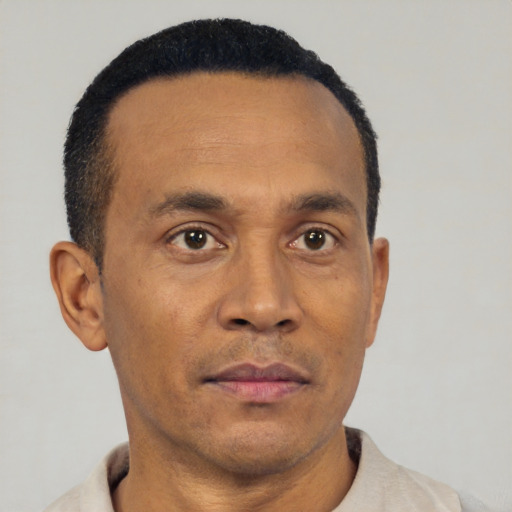 Neutral latino adult male with short  brown hair and brown eyes
