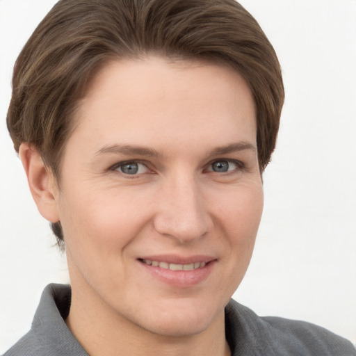 Joyful white young-adult female with short  brown hair and grey eyes