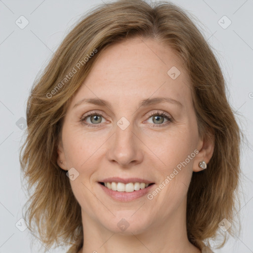 Joyful white adult female with medium  brown hair and grey eyes