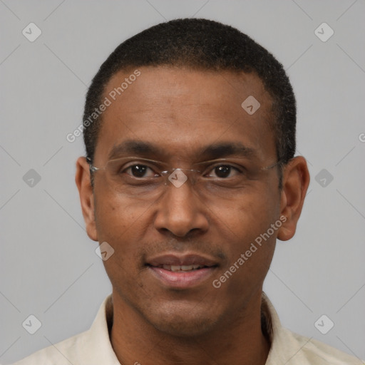 Joyful black adult male with short  black hair and brown eyes
