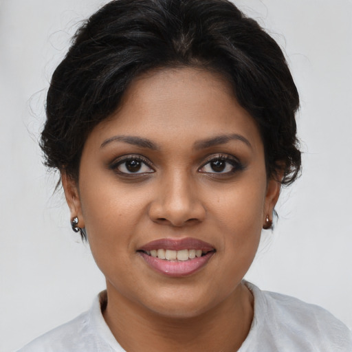 Joyful latino young-adult female with medium  brown hair and brown eyes