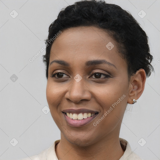 Joyful latino young-adult female with short  black hair and brown eyes