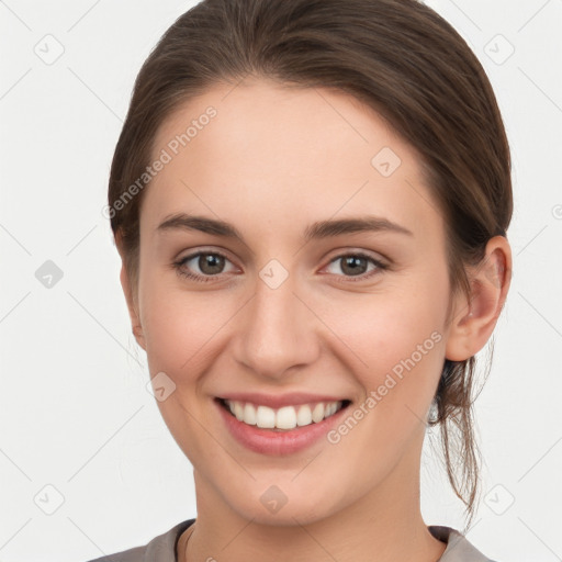 Joyful white young-adult female with medium  brown hair and grey eyes