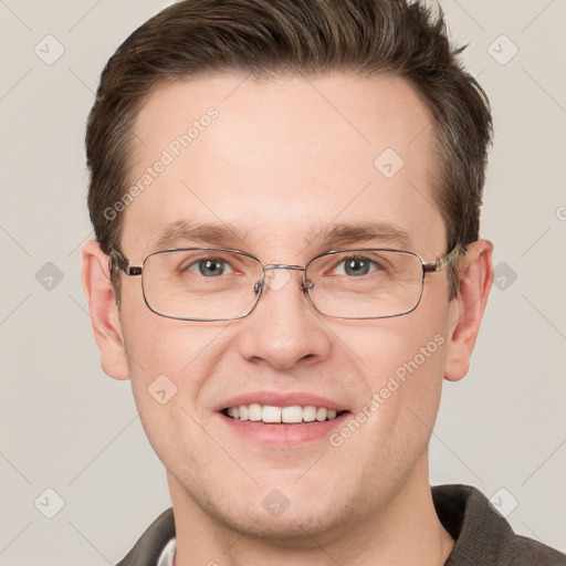 Joyful white adult male with short  brown hair and grey eyes