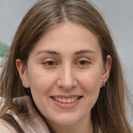 Joyful white adult female with long  brown hair and brown eyes