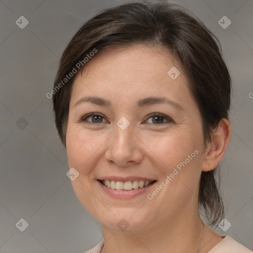 Joyful white adult female with medium  brown hair and brown eyes