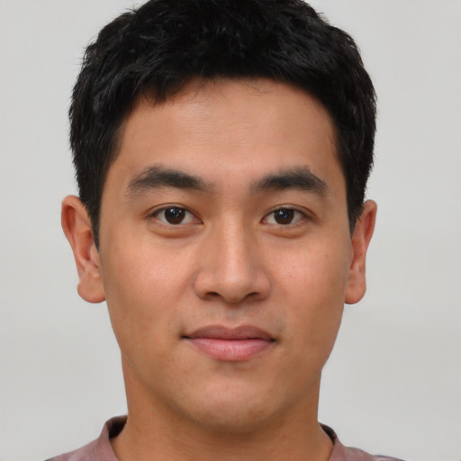Joyful asian young-adult male with short  black hair and brown eyes