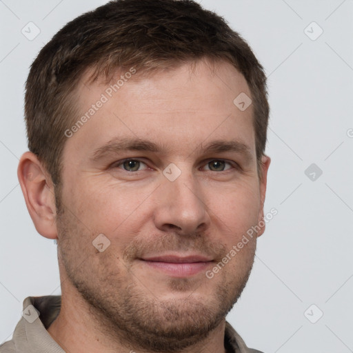 Joyful white young-adult male with short  brown hair and grey eyes