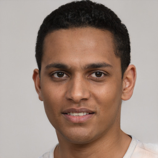 Joyful latino young-adult male with short  black hair and brown eyes