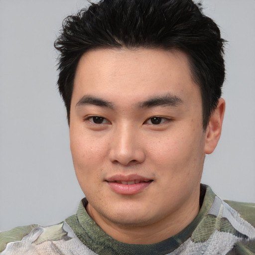 Joyful asian young-adult male with short  black hair and brown eyes