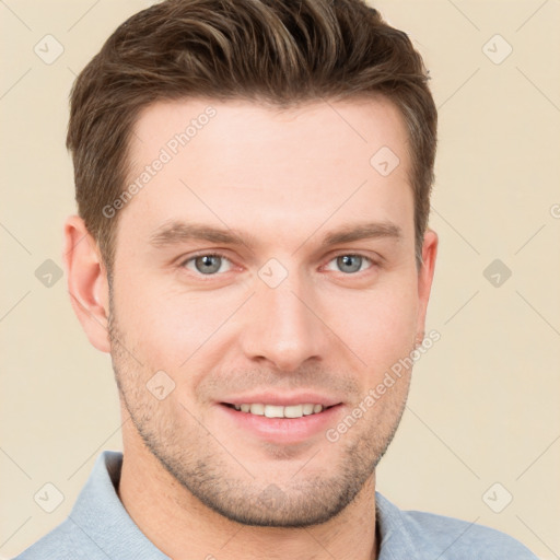 Joyful white young-adult male with short  brown hair and grey eyes