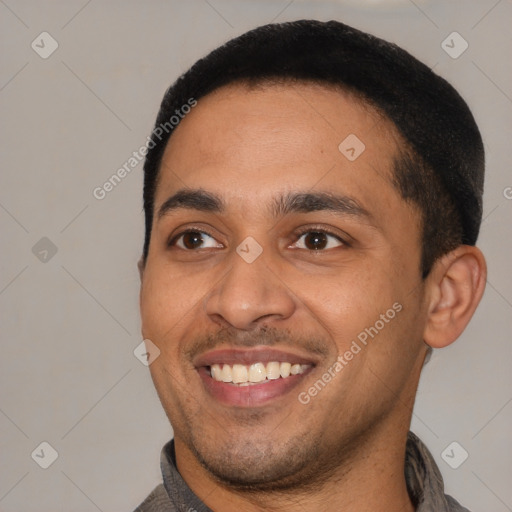 Joyful latino young-adult male with short  black hair and brown eyes