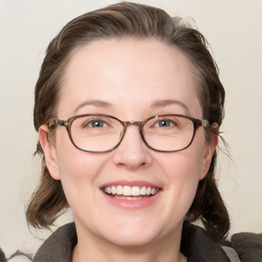 Joyful white adult female with medium  brown hair and blue eyes