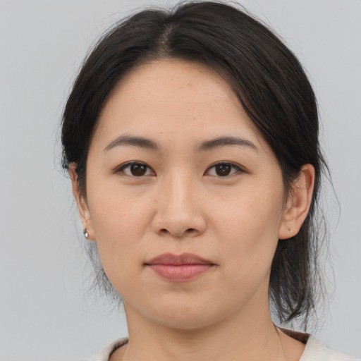Joyful asian young-adult female with medium  brown hair and brown eyes