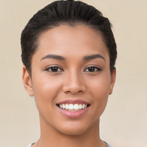 Joyful latino young-adult female with short  black hair and brown eyes