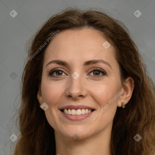 Joyful white adult female with long  brown hair and brown eyes