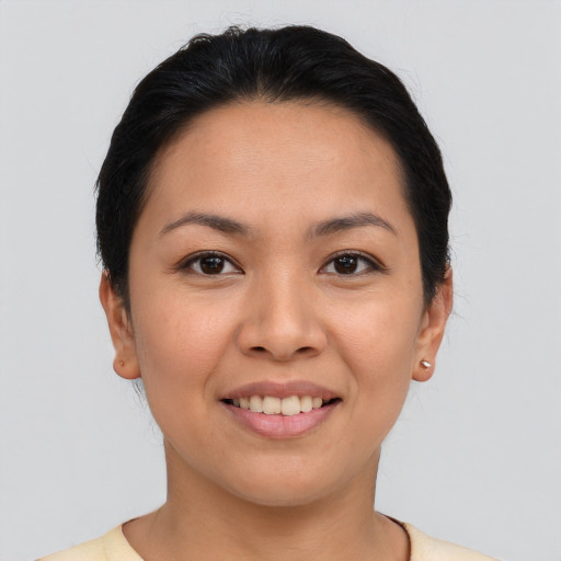 Joyful asian young-adult female with short  brown hair and brown eyes
