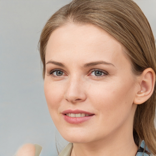 Joyful white young-adult female with medium  brown hair and blue eyes