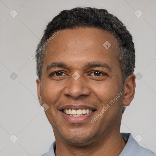 Joyful latino adult male with short  black hair and brown eyes