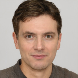 Joyful white adult male with short  brown hair and grey eyes