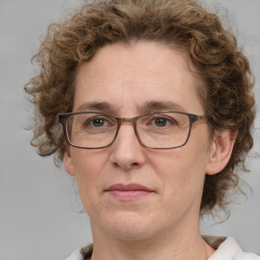 Joyful white adult female with medium  brown hair and blue eyes