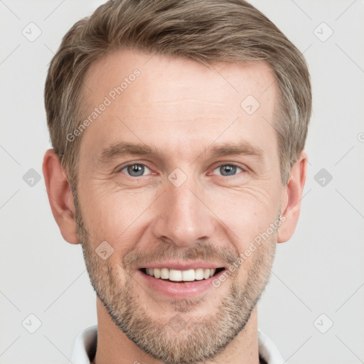 Joyful white adult male with short  brown hair and grey eyes