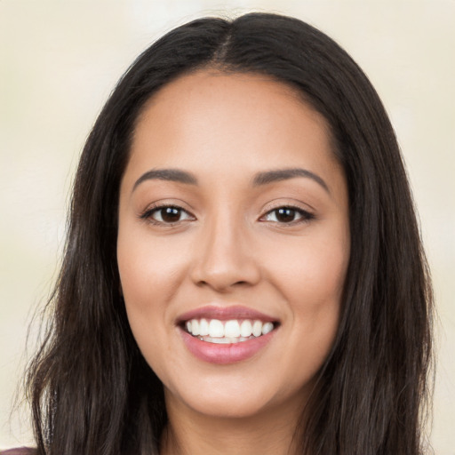 Joyful latino young-adult female with long  black hair and brown eyes