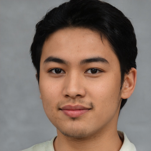 Joyful asian young-adult male with short  black hair and brown eyes