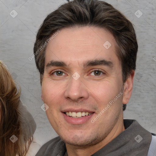 Joyful white adult male with short  brown hair and brown eyes