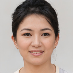 Joyful asian young-adult female with short  brown hair and brown eyes