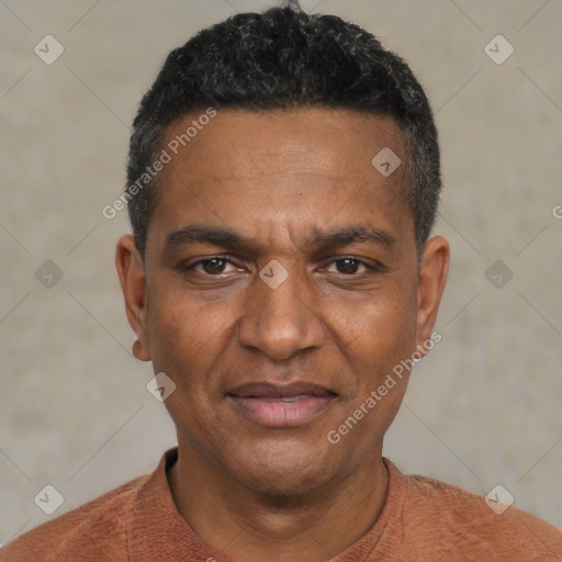 Joyful black adult male with short  black hair and brown eyes
