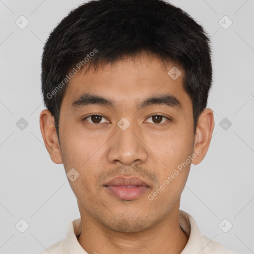 Joyful asian young-adult male with short  brown hair and brown eyes