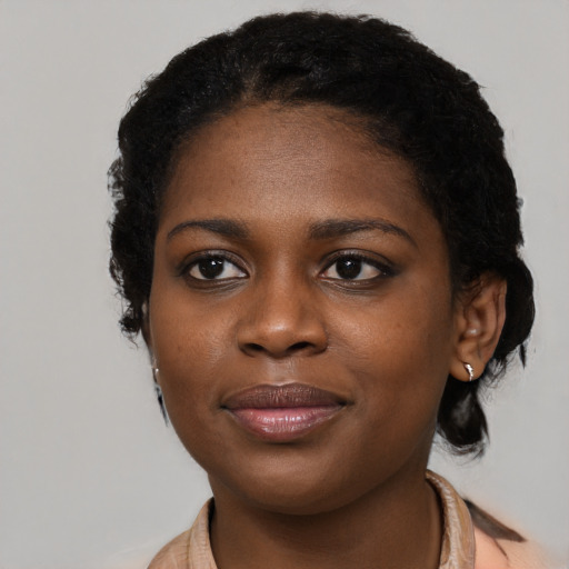 Joyful black young-adult female with medium  brown hair and brown eyes