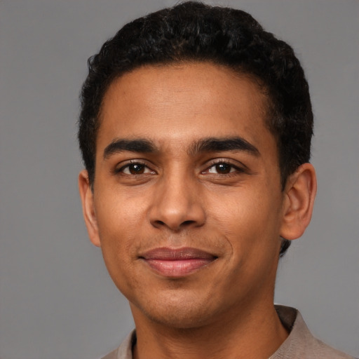 Joyful latino young-adult male with short  brown hair and brown eyes