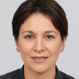 Joyful white adult female with short  brown hair and brown eyes