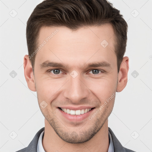 Joyful white young-adult male with short  brown hair and grey eyes