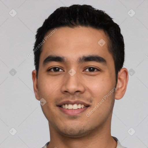 Joyful latino young-adult male with short  black hair and brown eyes