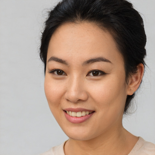 Joyful asian young-adult female with medium  brown hair and brown eyes