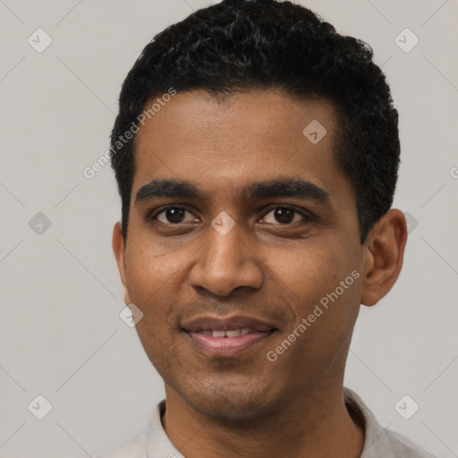 Joyful black young-adult male with short  black hair and brown eyes