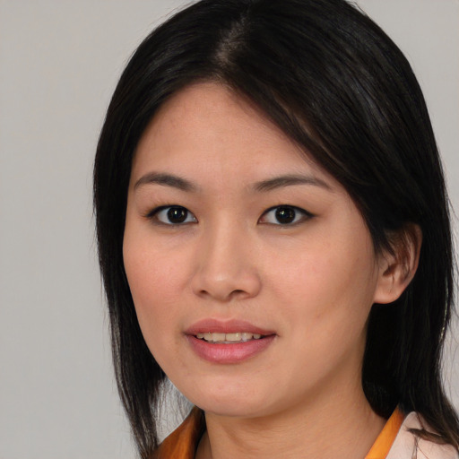 Joyful asian young-adult female with medium  black hair and brown eyes