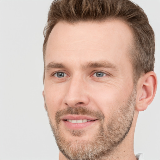 Joyful white adult male with short  brown hair and grey eyes