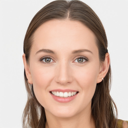 Joyful white young-adult female with long  brown hair and blue eyes