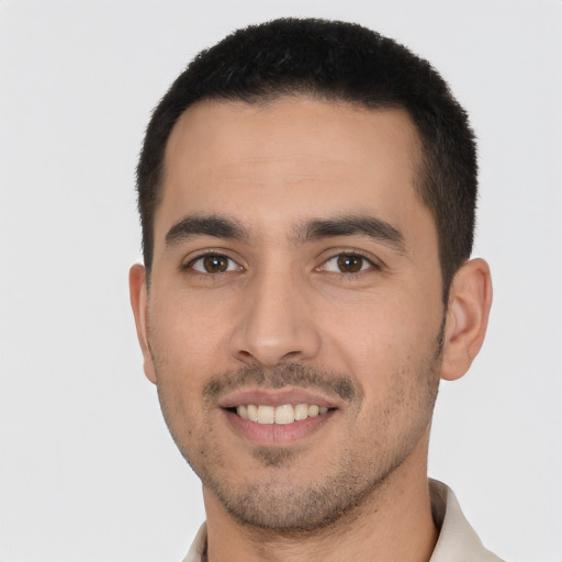 Joyful white young-adult male with short  black hair and brown eyes