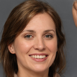 Joyful white adult female with medium  brown hair and grey eyes