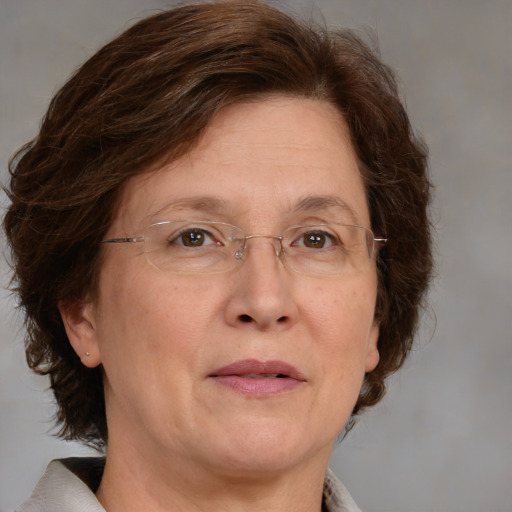 Joyful white adult female with medium  brown hair and green eyes