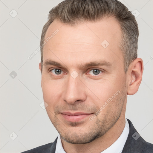 Joyful white adult male with short  brown hair and brown eyes