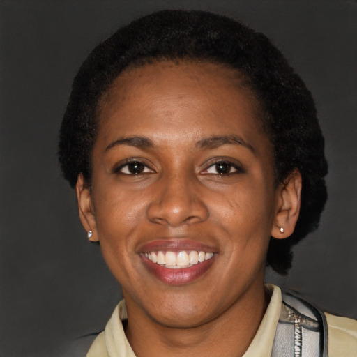 Joyful latino adult female with short  black hair and brown eyes