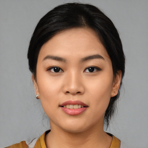 Joyful asian young-adult female with medium  black hair and brown eyes