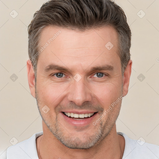 Joyful white adult male with short  brown hair and brown eyes