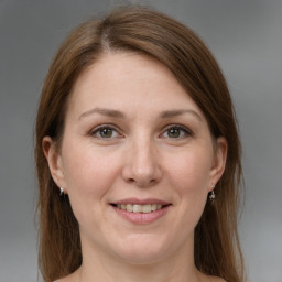 Joyful white adult female with medium  brown hair and grey eyes